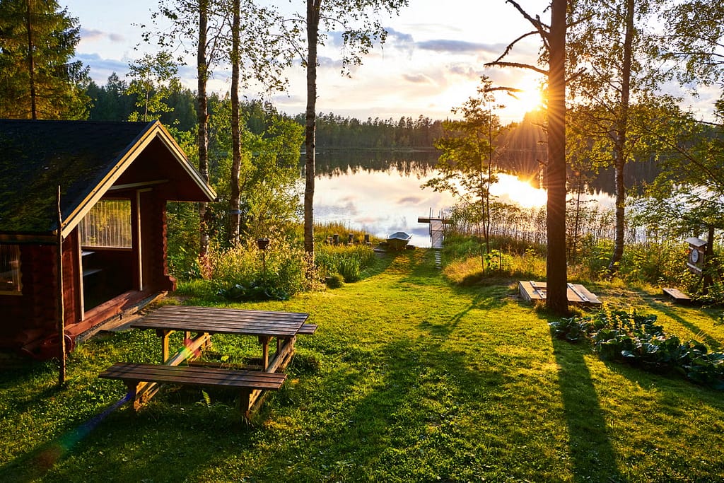 The village like part of Finland with lakes and trees and hut houses. 