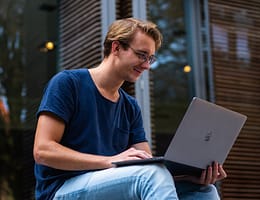 selective focus photo of man using laptop