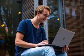 selective focus photo of man using laptop